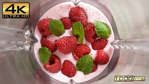 Raspberry Pink Yogurt Shake With Mint Leaf Mixed In A Glass Blender In Slow Motion, Top View