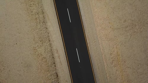 A road in the desert. Sand and outdoor road travel and journey. Freedom for transport and travel.