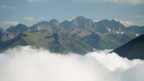8K High Rocky Peaks Above The Clouds Covering Valley