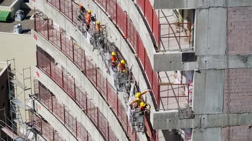 Construction Workers Building Modern Curved Building