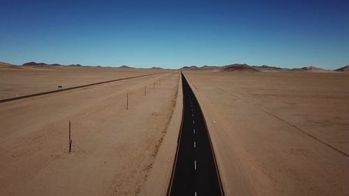 A road in the desert. Sand and outdoor road travel and journey. Freedom for transport and travel.