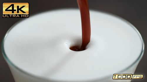 Espresso Pours into Glass of Steamed Milk