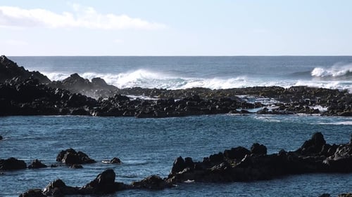 Ocean waves crush the pebble rocks of the beach in Iceland. . Splashes of sea storm water foam.