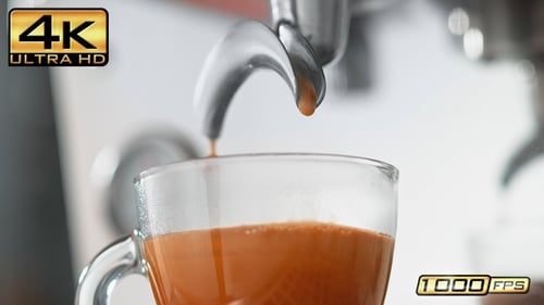 Espresso Pouring Into Clear Glass Cup Close Up