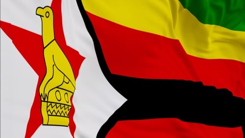 The Zimbabwe flag with alpha channel waving in the wind in slow motion