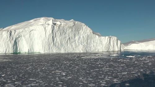 Majestic Iceberg Floating in Arctic Waters on Sunny Day