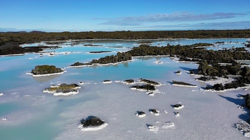 Blue Lagoon. Geothermal hot spring. Blue waters in the lake. Flying over open natural pool. Iceland.