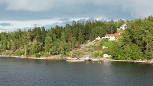 Stockholm archipelago in the Baltic Sea. Picturesque shores of the fjord. Residential buildings.