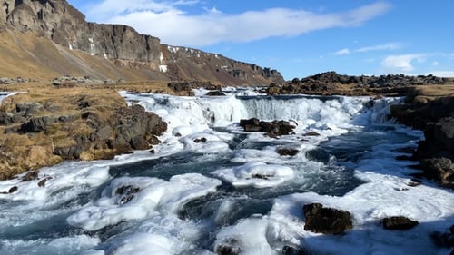 Nature. Winter. Frozen waterfall in winter, a magical winter location of snow and ice. Iceland.