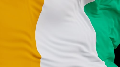 The Ivory Coast flag with alpha channel waving in the wind in slow motion