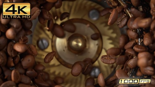Grinding Roasted Coffee Beans Spinning In Burr Grinder In Slow Motion and Macro - Top View