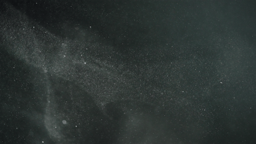 White Particles Floating on a Dark Background