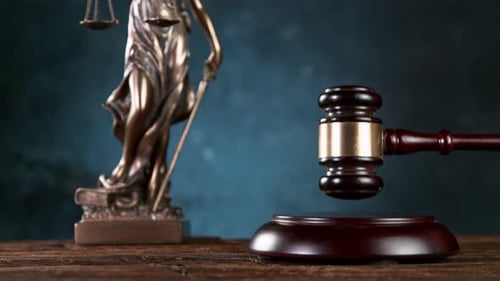 Super slow motion of gavel being struck to decide an auction or guilty verdict in court .