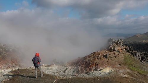 Iceland. Hot steam above the ground. Smoking fumaroles. Volcanic landscape. Wonders of nature.