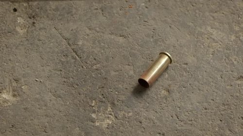 Pistol Bullet Cartidge Falls Om The Floor
