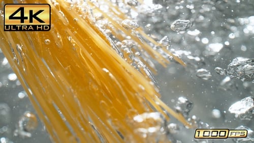 Dropping Spaghetti Strands into Boiling Water - Underwater View Below the Surface in Slow Motion