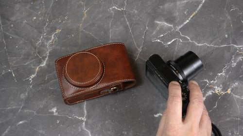Person Turns Off And Puts The Camera In The Case