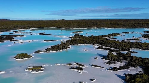Blue waters, unique geological formations at a natural lagoon surrounded by lava fields in Iceland.