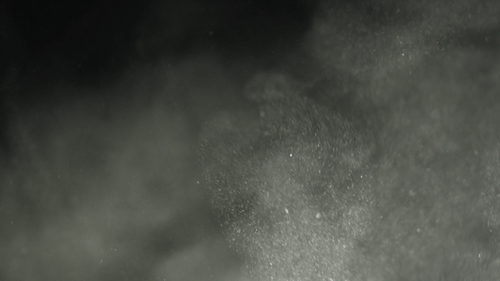 Atmospheric White Dust Particles Swirling on Black Background