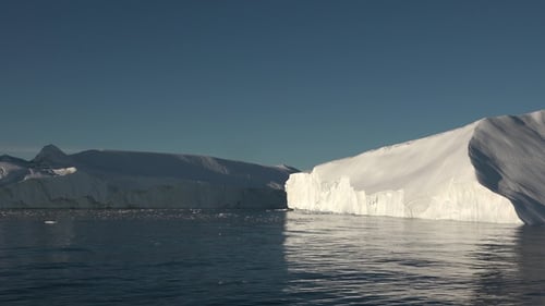 Arctic Icebergs Floating on Calm Water