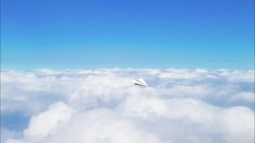 Paper Airplane Flying Through Blue Sky and Clouds