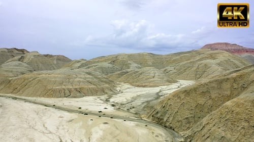 Barren Desert Landscape with Eroded Hills and Dry Riverbeds