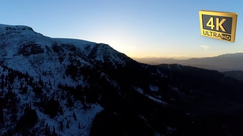 Aerial Shot of Snowy Mountains During Sunrise 1