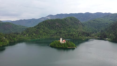 Landscape of Bled Island, charming chapel, of majestic mountains and serene waters.