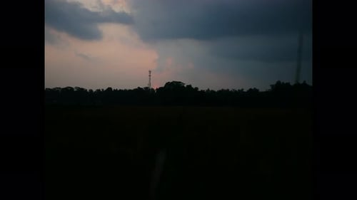 Sunset Over Rural Landscape With Communication Tower