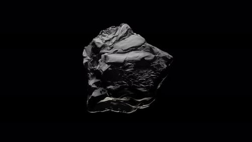 Rotating black rock with studio light