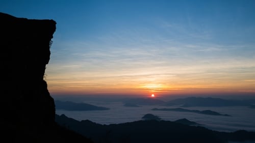 Sunrise Over Misty Mountains in Golden Light