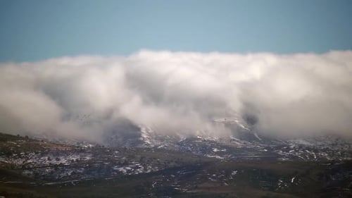 8K Mist Cloud Flowing Down Ridge of Mountain Range