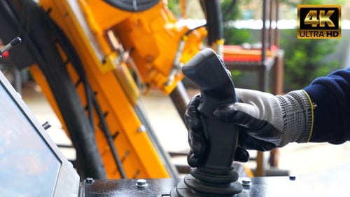 Engineer Using Machine With Joistik