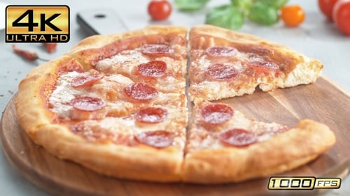 Pizza Pepperoni Slices Disappearing From A Wooden Serving Tray - Table Top View, Stop Motion
