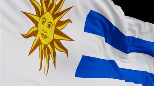 The Uruguay flag with alpha channel waving in the wind in slow motion