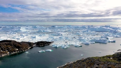 Frozen Arctic Icebergs and Islands Aerial View