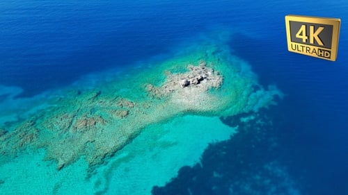 A Small Island In Magnificent Blue Waters