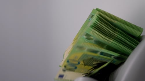 Counting Stack of Green Euro Banknotes With Machine