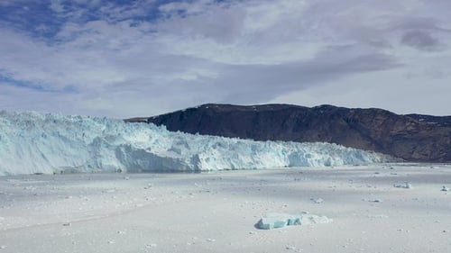 Glimpse of majestic icebergs floating in the serene waters of Greenland’s Ilulissat Icefjord.