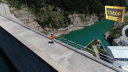 Man Walking On Dam 13