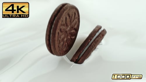 Chocolate Cookies Splashing Into Refreshing Milk