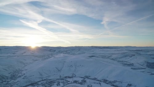 Winter Sunrise Over Snow Covered Rural Hills