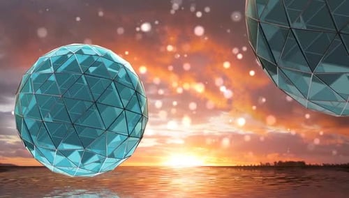Rotating Geometric Glass Spheres on Sunset Water Background