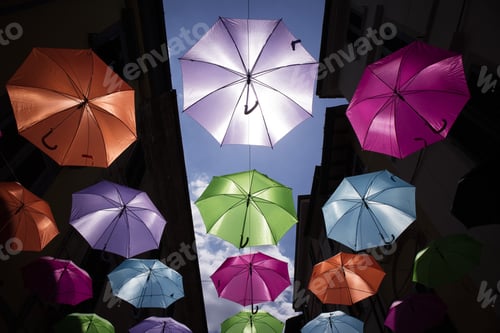 Preview: A Series Of Umbrellas Of Different Colors Hung With A Steel Wire