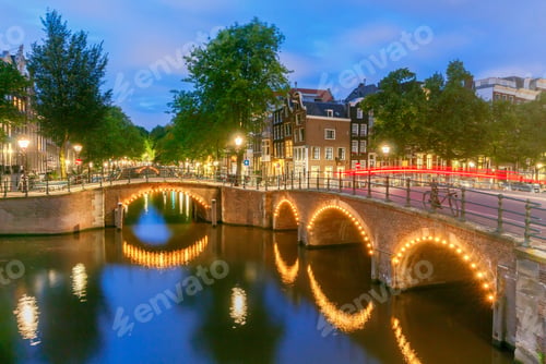 Preview: City Canal With Glowing Lights Early In The Morning. Amsterdam. Netherlands.