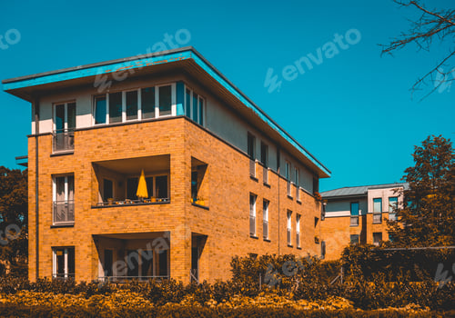 Preview: Orange Colored Brick Apartment Building With Darken Sky