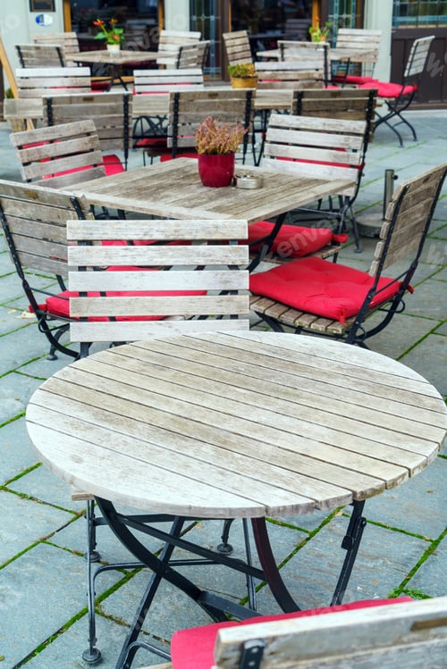 Preview: Wooden Furniture, Tables And Chairs With Red Pillows Of A Street Cafe