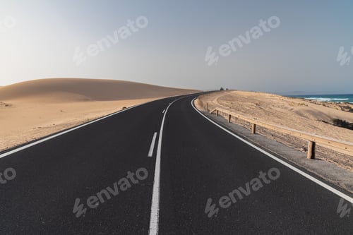 Preview: Asphalt Road On Desert Sand Dune At Sunset In Corralejo Natural Park In Canary Islands