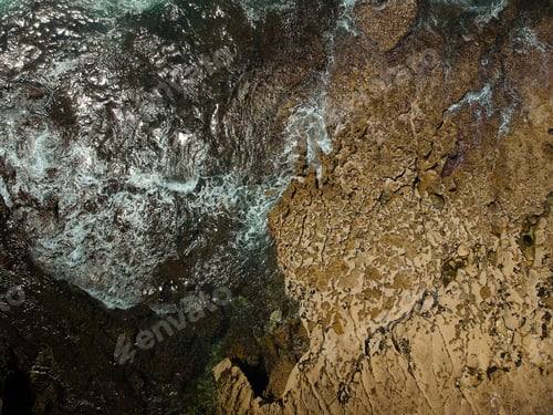 Preview: Aerial View Of Sea Waves Crash On The Rocks In The Coastline