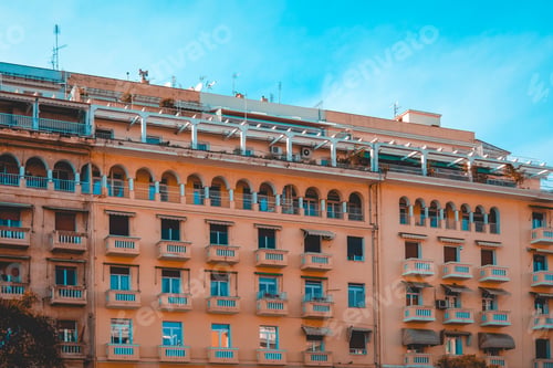 Preview: Orange Big Apartment Complex With White Rooftop Balcony
